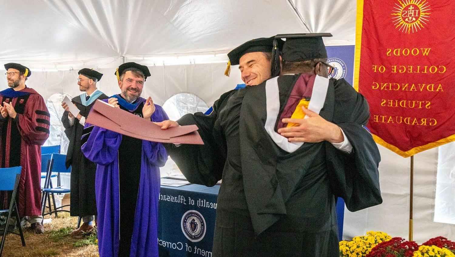 a graduation ceremony with people in cap and gown